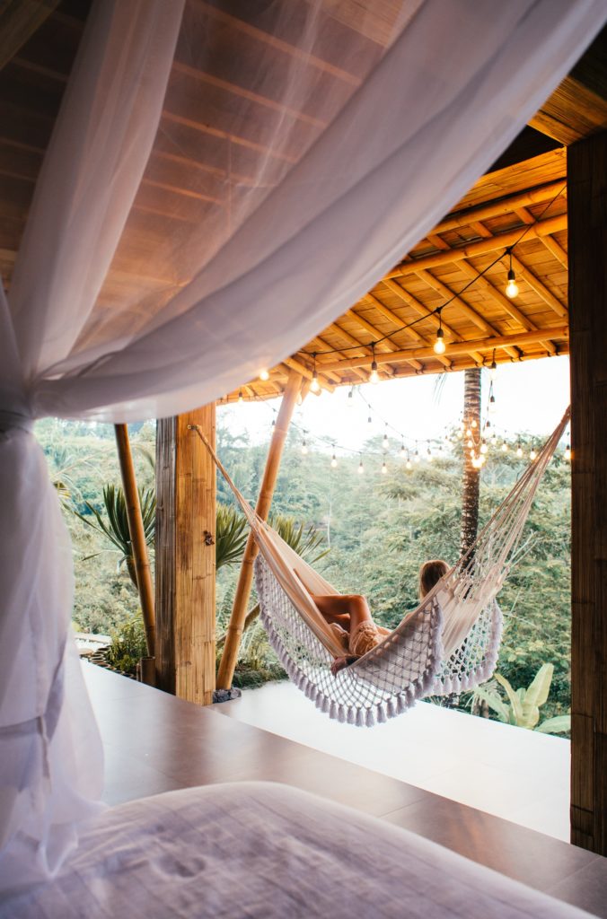 travel alone woman sunbathing on a hammock