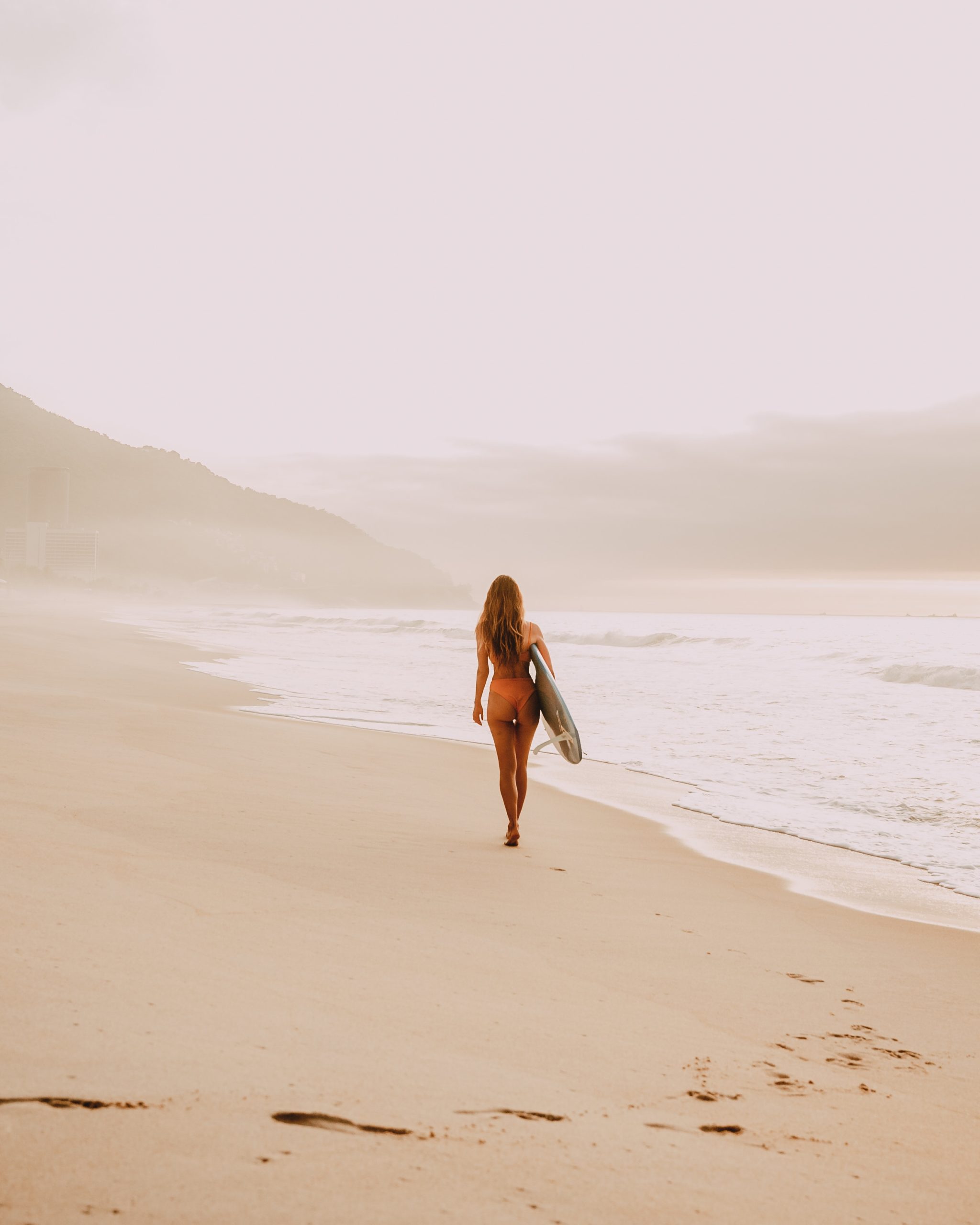 girl in a bikini walking beside the beach