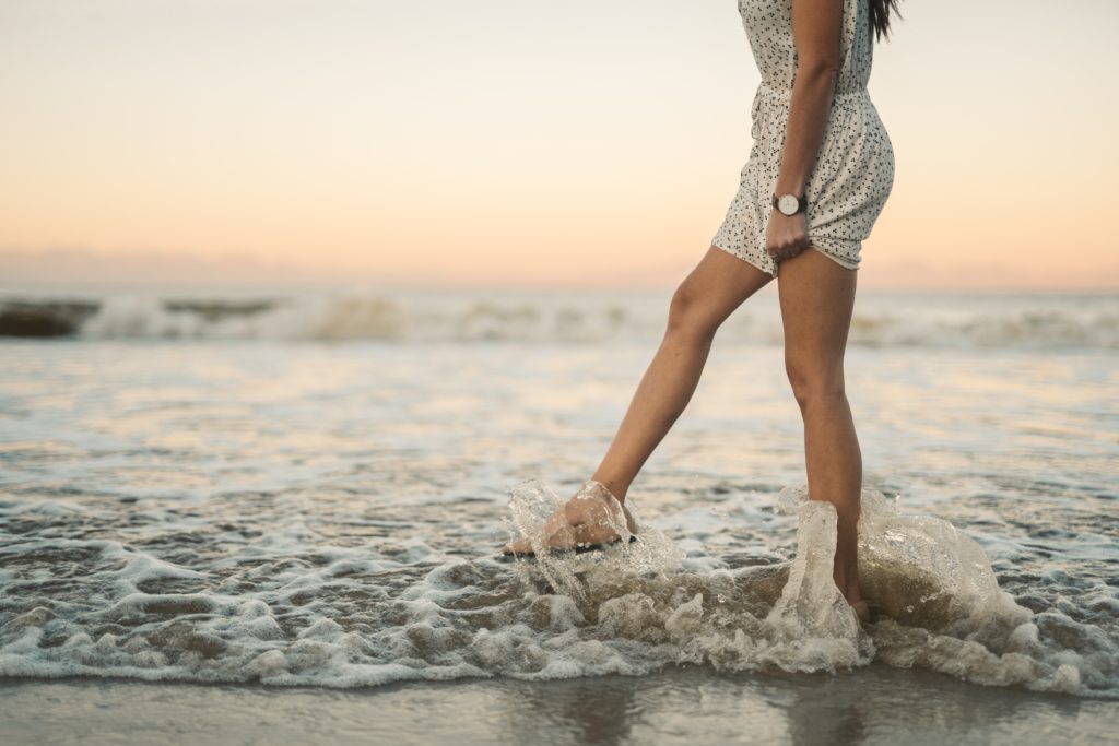 woman in a dress walking alone at the beach - Copy